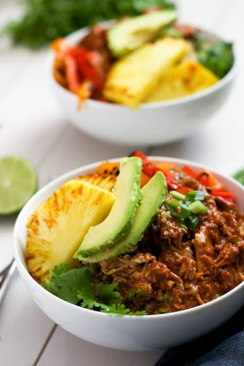 Slow Cooker Hawaiian Pork Burrito Bowls are a dinner saver as they cook all day in a homemade enchilada sauce then topped with sautéed peppers and juicy, seared pineapple!