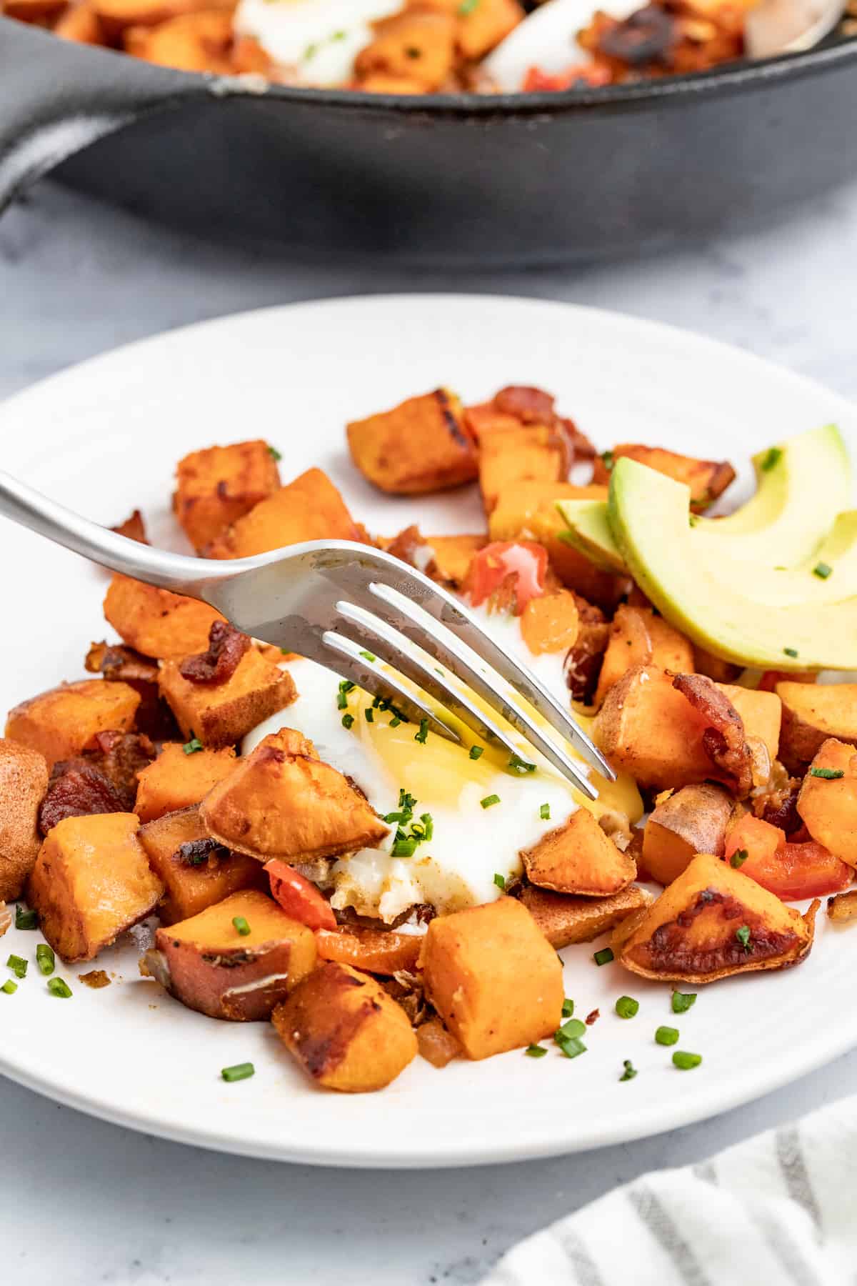 Digging the fork into the sweet potato hash. 