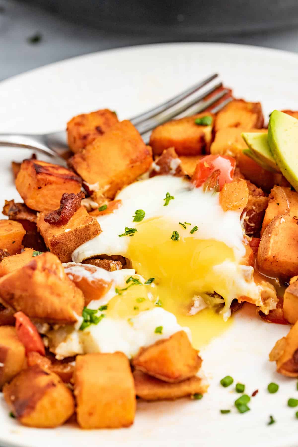 Runny egg in sweet potato hash.