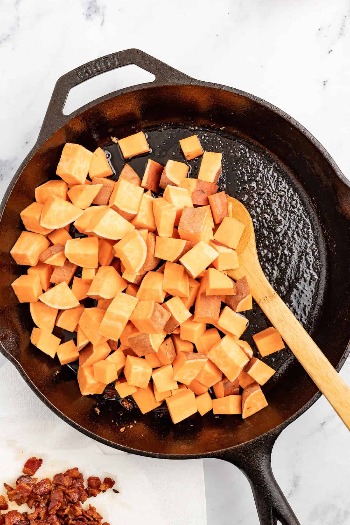 Adding the sweet potatoes to the skillet. 