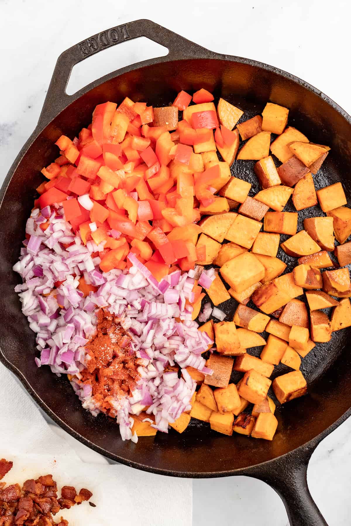 Adding the veggies to the skillet. 