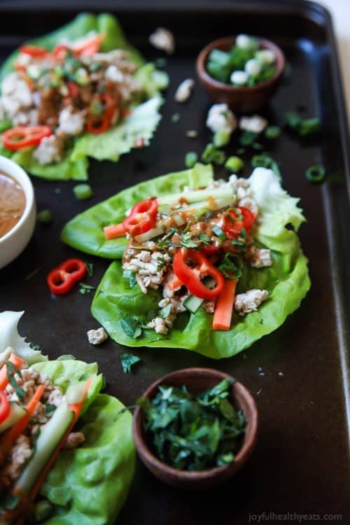 Three Thai Chicken Lettuce Wraps with Spicy Peanut Sauce on a Baking Sheet