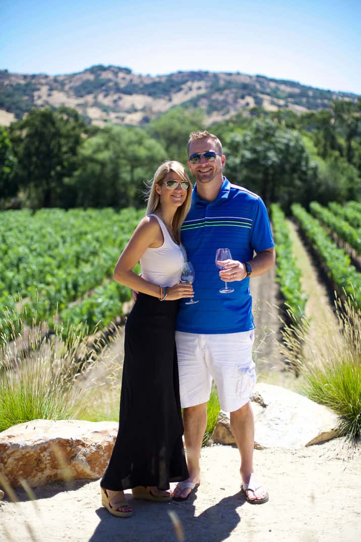 a couple in front of a stags leap winery vineyard in napa valley california