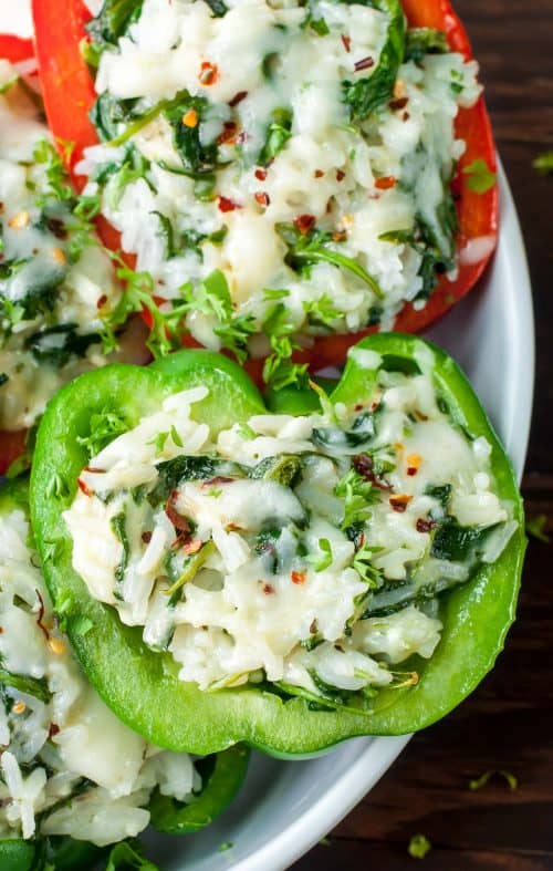 Close-up Shot of a Red and a Green Cheesy Spinach Stuffed Pepper