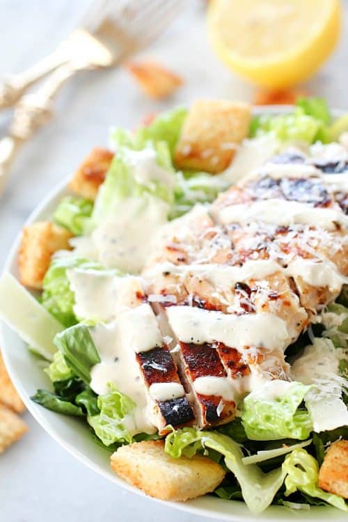 Grilled Chicken Caesar Salad – with a simple marinade recipe, this grilled chicken is tender and delicious! Served over romaine, shaved parmesan, homemade croutons & Caesar Dressing