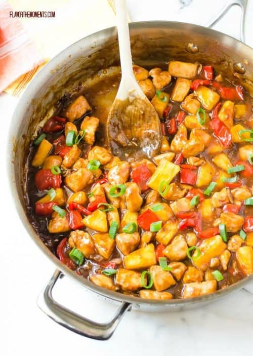 A Honey Pineapple Chicken Teriyaki Skillet with a Wooden Spoon Inside