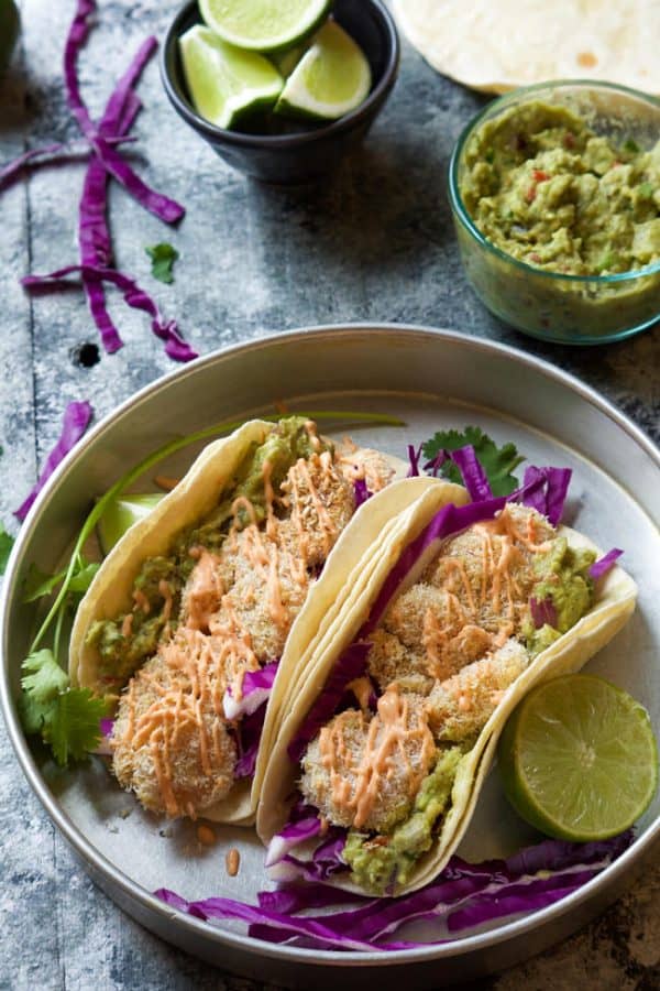 A skinny makeover of a restaurant classic! Skinny Baked Bang Bang Shrimp Tacos combine two of my favorites into one flavorful dish that is ready in 20 minutes!