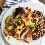 pan seared chicken with peach salsa on a plate