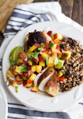 pan seared chicken with peach salsa on a plate