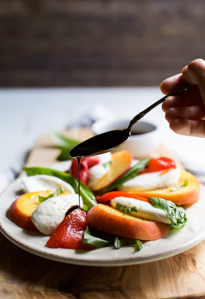 A light, refreshing, irresistible Roasted Red Pepper Peach Caprese drizzled with a homemade Balsamic Reduction. It's like a flavor bomb went off in your mouth! | joyfulhealthyeats.com #glutenfree #vegetarian