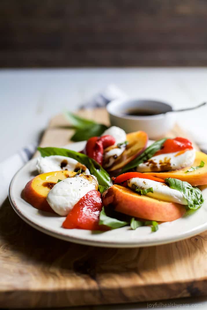 A light, refreshing, irresistible Roasted Red Pepper Peach Caprese drizzled with a homemade Balsamic Reduction. It's like a flavor bomb went off in your mouth! | joyfulhealthyeats.com #glutenfree #vegetarian