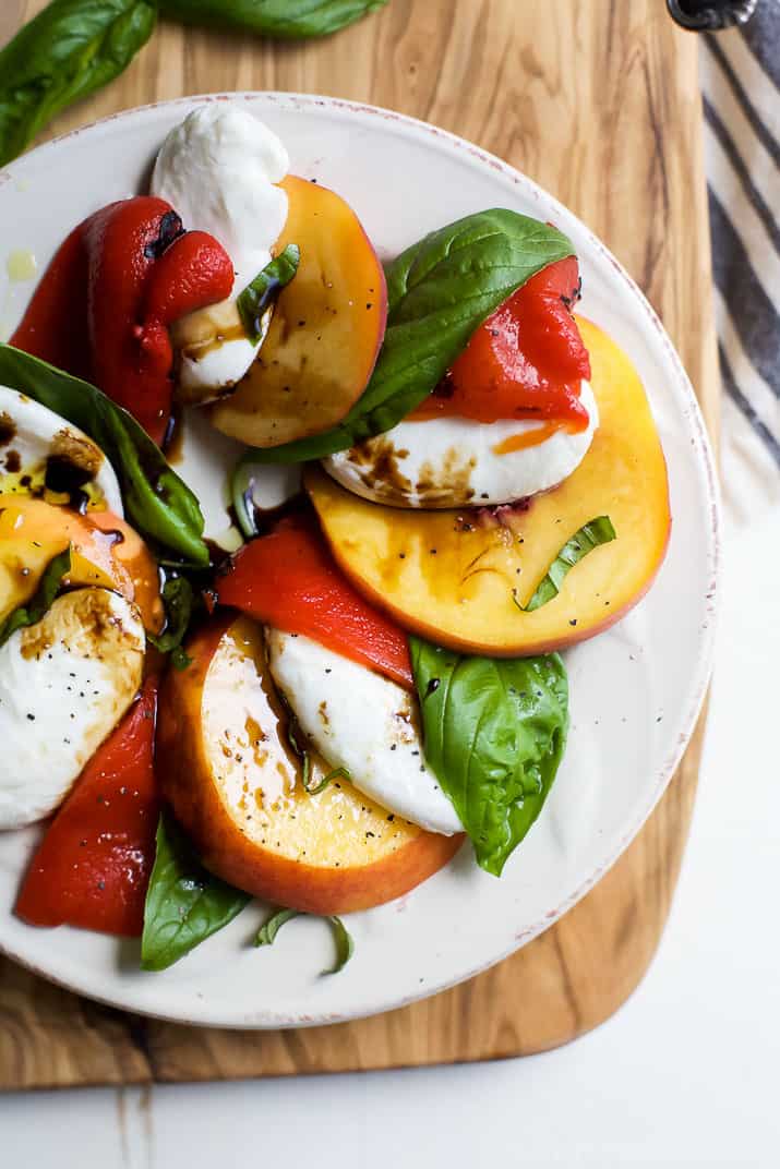 A light, refreshing, irresistible Roasted Red Pepper Peach Caprese drizzled with a homemade Balsamic Reduction. It's like a flavor bomb went off in your mouth! | joyfulhealthyeats.com #glutenfree #vegetarian