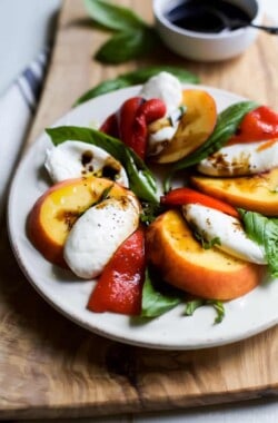 A light, refreshing, irresistible Roasted Red Pepper Peach Caprese drizzled with a homemade Balsamic Reduction. It's like a flavor bomb went off in your mouth! | joyfulhealthyeats.com #glutenfree #vegetarian