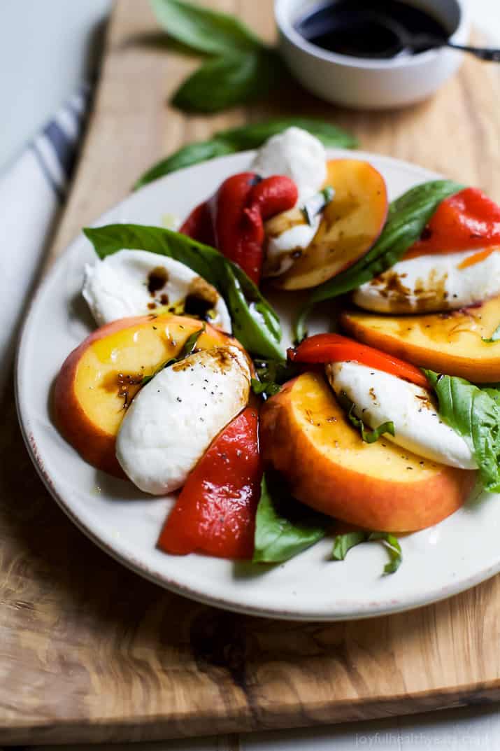 A light, refreshing, irresistible Roasted Red Pepper Peach Caprese drizzled with a homemade Balsamic Reduction. It's like a flavor bomb went off in your mouth! | joyfulhealthyeats.com #glutenfree #vegetarian