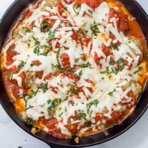 Overhead view of baked turkey meatballs in cast iron skillet