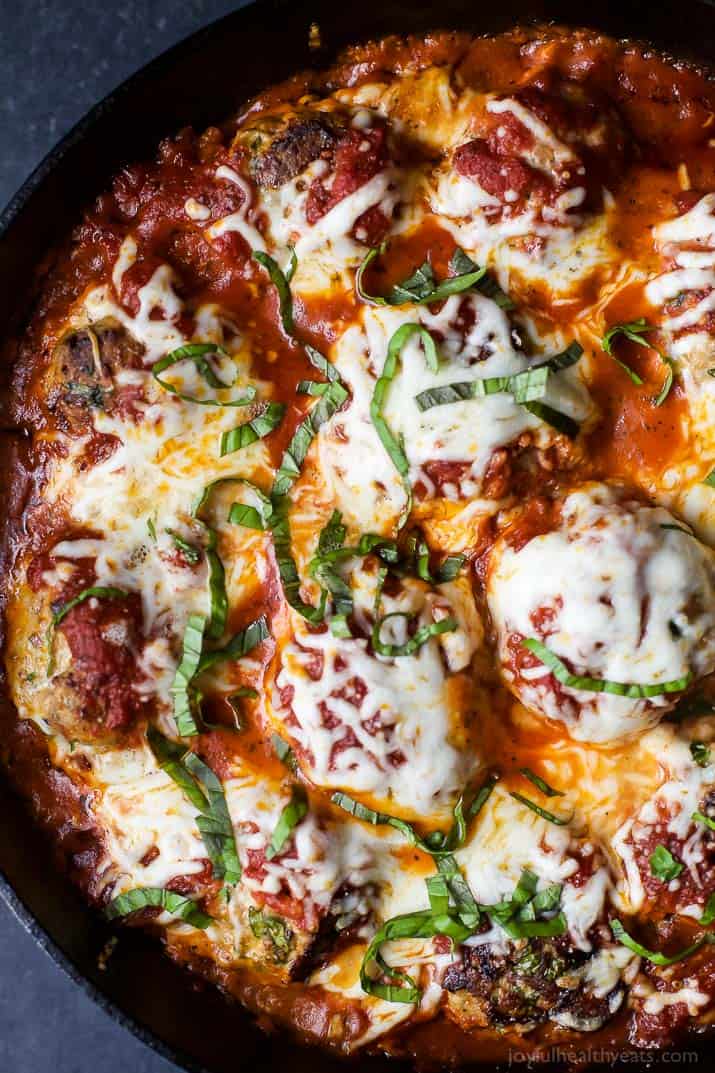 Top view of a pan of Cheesy Baked Turkey Meatballs cooked in Marinara sauce