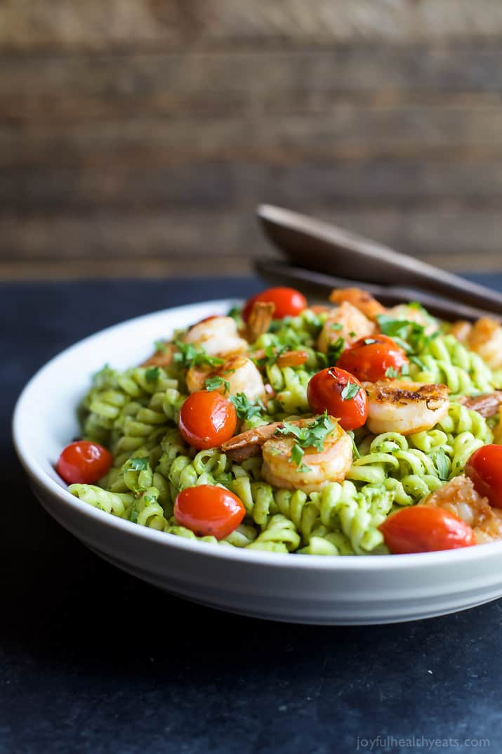 Chimichurri Avocado Pasta with Pan Seared Shrimp and grape tomatoes in a bowl