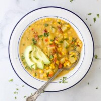 overhead crock pot potato corn chowder in a bowl with a spoon