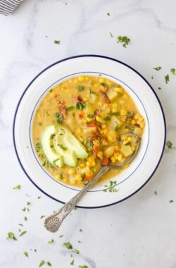 overhead crock pot potato corn chowder in a bowl with a spoon