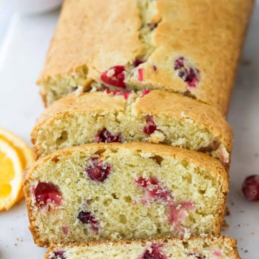 Three slices cut from orange cranberry bread loaf.