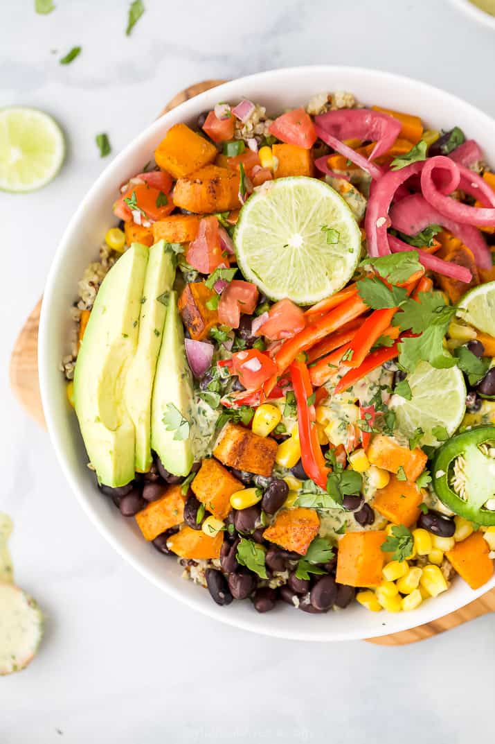 close up of easy sweet potato black bean quinoa bowls with crema and avocado