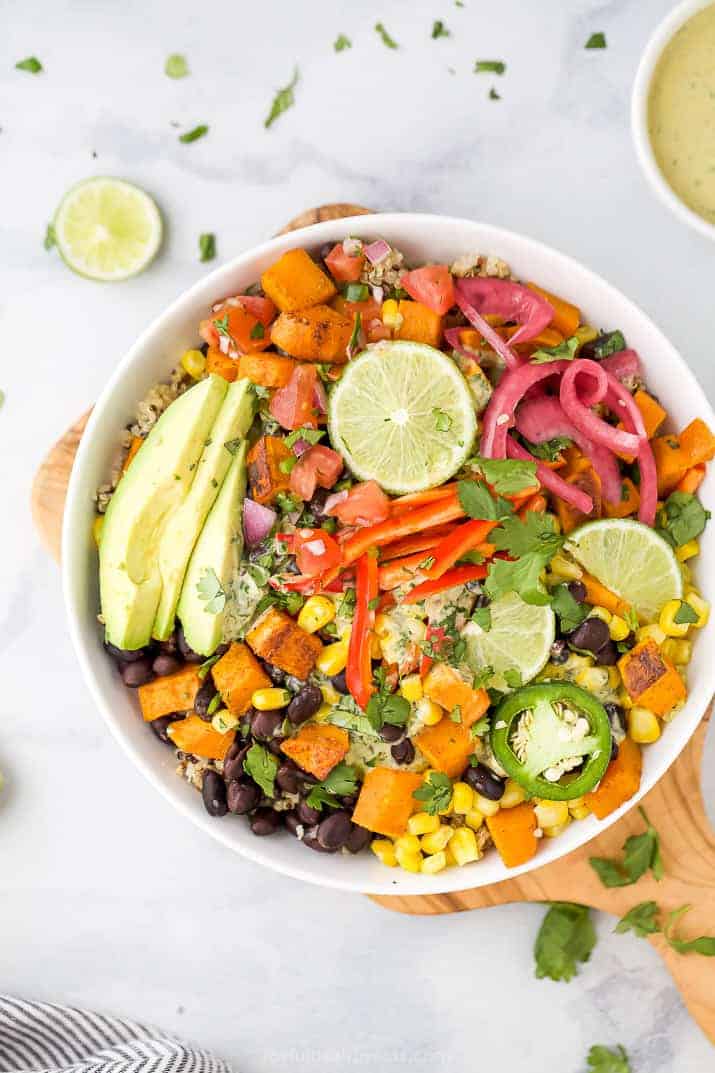 overhead photo of easy sweet potato black bean quinoa bowls with crema in a bowl