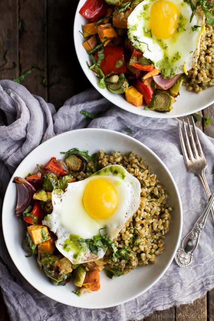 Top view of Harvest Roasted Vegetable Grain Bowls topped with a fried egg