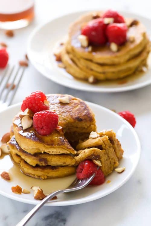 Gluten Free Pumpkin Pancakes are filled with fall flavors! They are super fluffy, have a touch of sweetness and finished with a warm coconut maple syrup! The ideal fall breakfast!