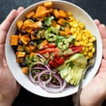 sweet potato black bean quinoa bowl with cilantro lime crema in a bowl