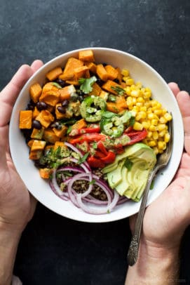 sweet potato black bean quinoa bowl with cilantro lime crema in a bowl