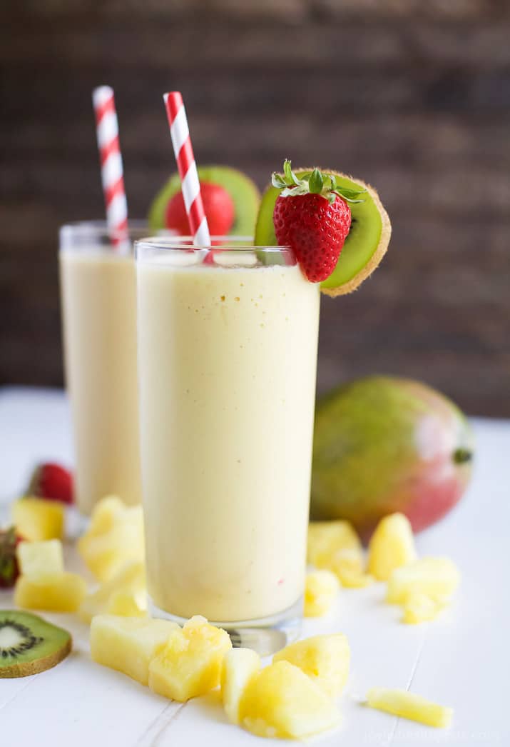 This refreshing Tropical Mango Smoothie is the perfect way to start your day. Fresh flavors that will take you straight to the beach and with 21 grams of protein! | joyfulhealthyeats.com | #drinkitallin #ad 