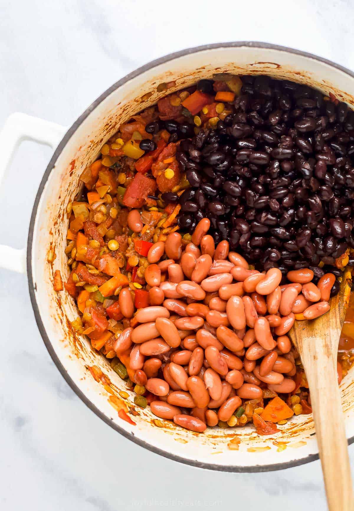 Lentil chili with beans in a dutch oven.