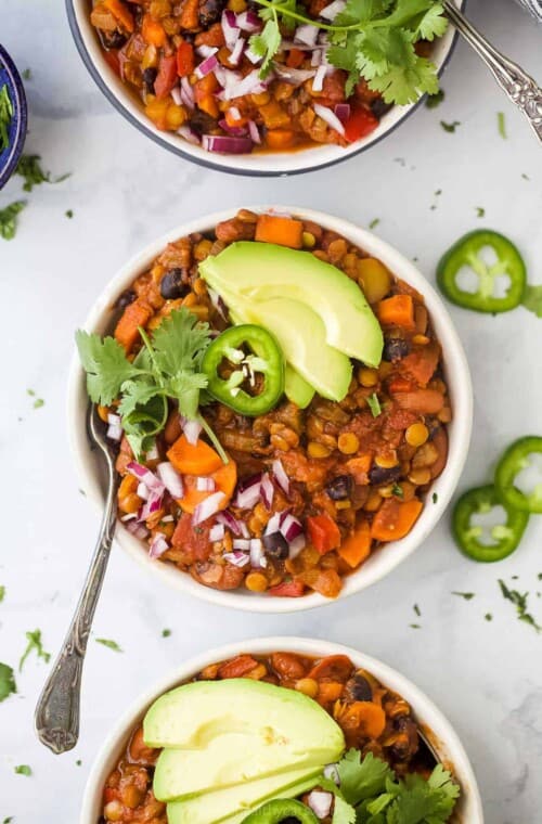 vegetarian lentil chili in a bowl with toppings