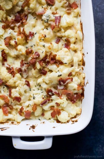 BACON CAULIFLOWER AU GRATIN, a creamy white cheddar cheese sauce tossed with cauliflower, fresh thyme and topped with bacon. A must have side dish for this holiday season that takes comfort food to a new level! | joyfulhealthyeats.com #RealFoodSunday #ad #glutenfree