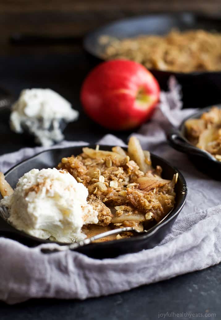 Cinnamon Apple Pear Crisp in a cast-iron skillet with vanilla ice cream