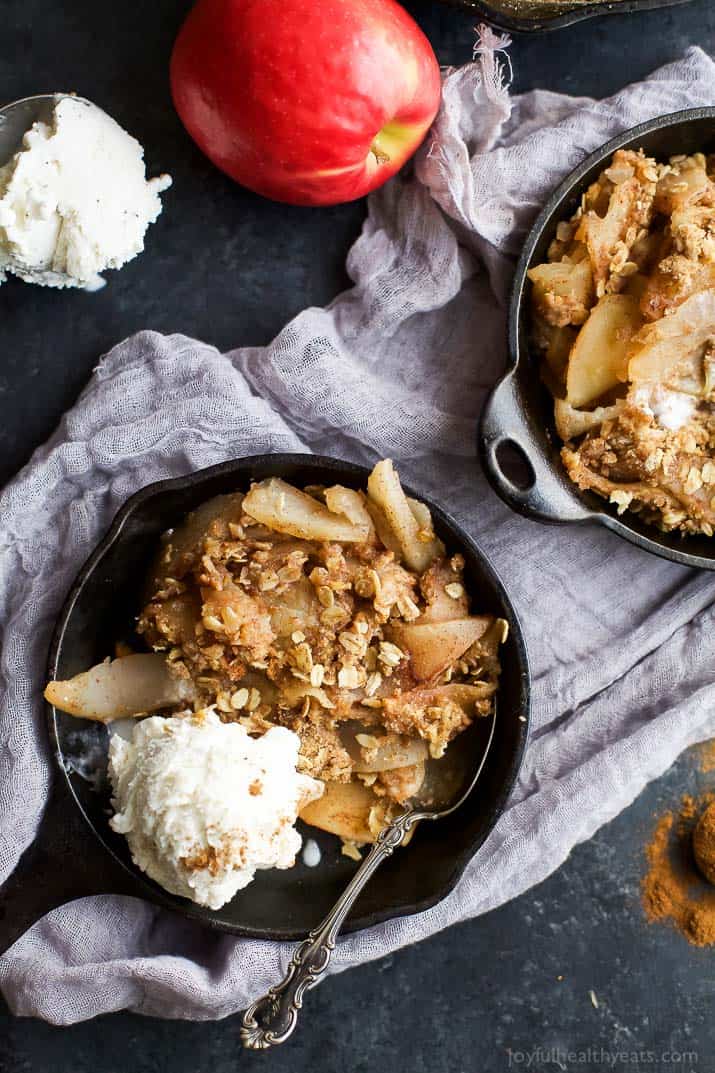 Top view of Cinnamon Apple Pear Crisp in a cast-iron skillet with vanilla ice cream