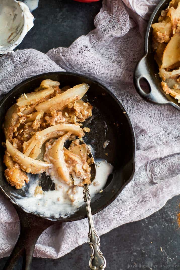 Top view of Cinnamon Apple Pear Crisp in a cast-iron skillet with vanilla ice cream