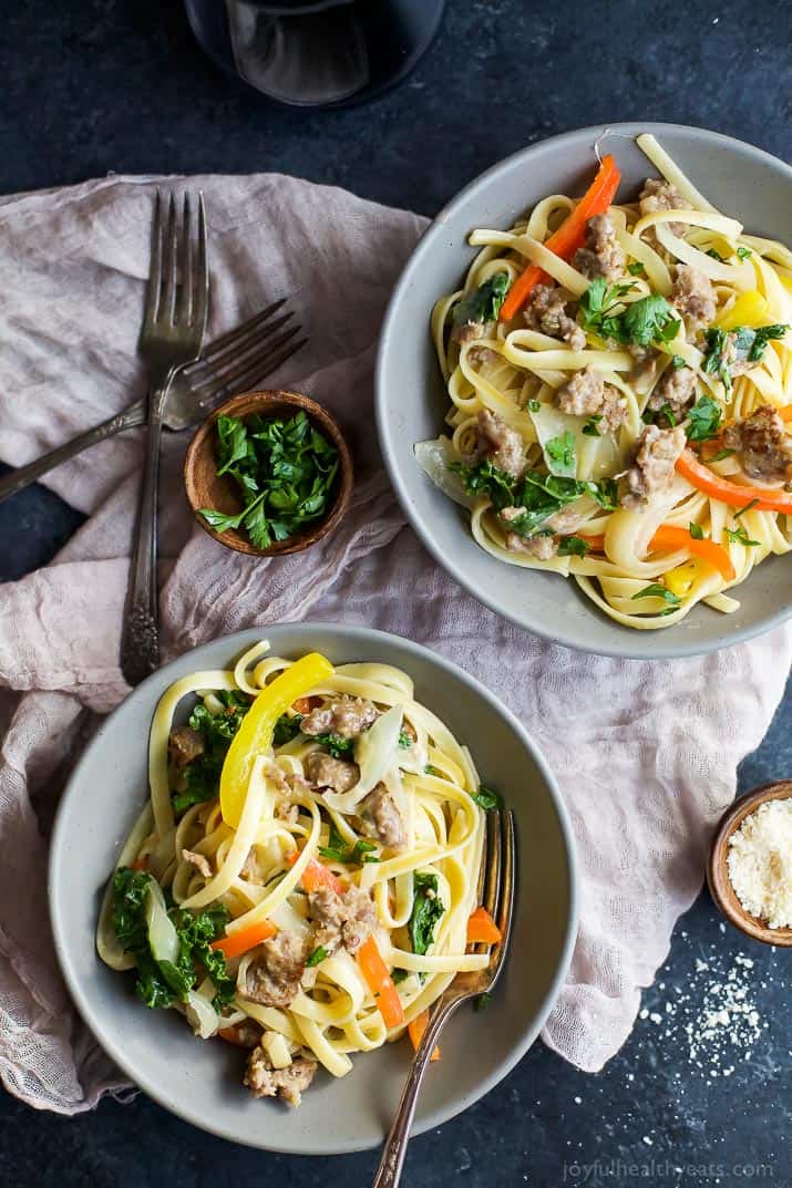 Top view of two bowls of Creamy Kale Pepper & Sausage Pasta