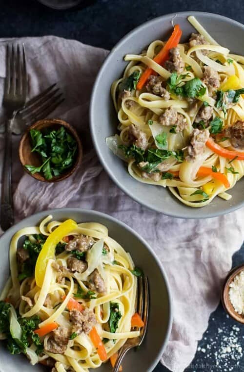 A quick and easy Creamy Kale Pepper & Sausage Pasta that's finished in just under 30 minutes! The perfect cheesy bowl of noodles you'll want to cozy up with at night! | joyfulhealthyeats.com