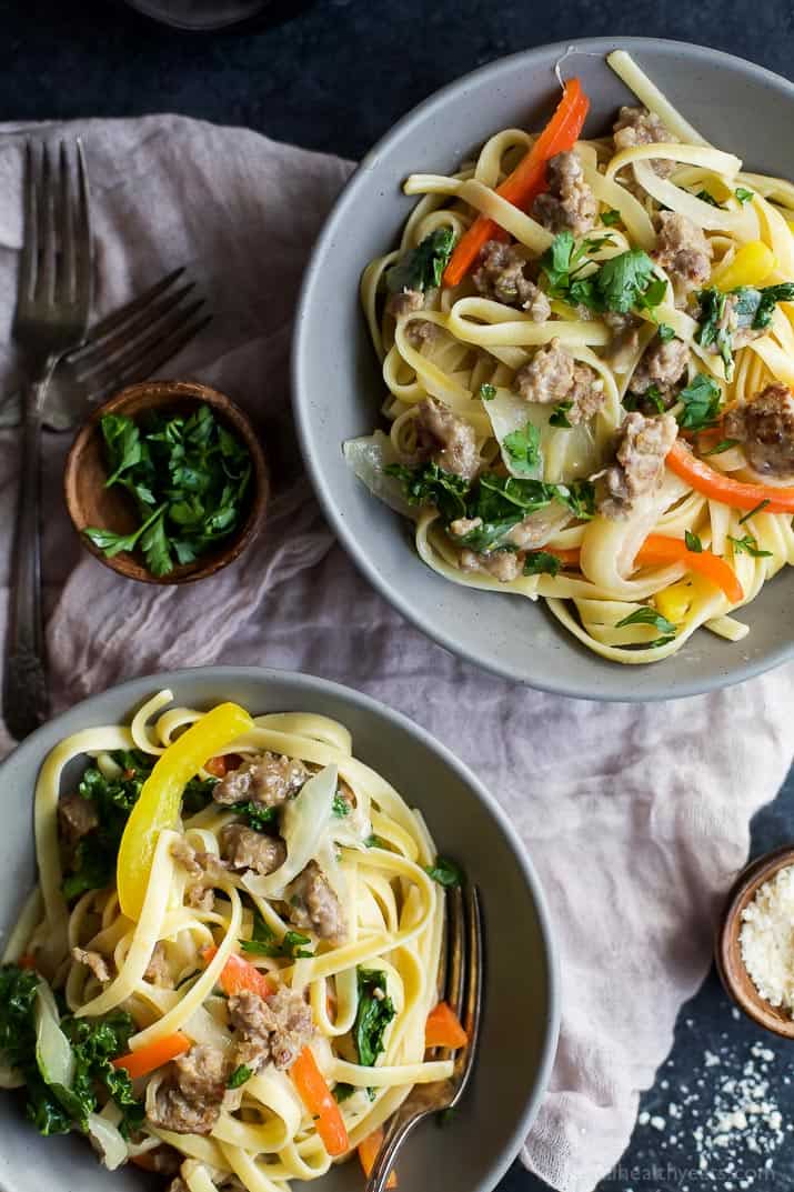 Top view of two bowls of Creamy Kale Pepper & Sausage Pasta