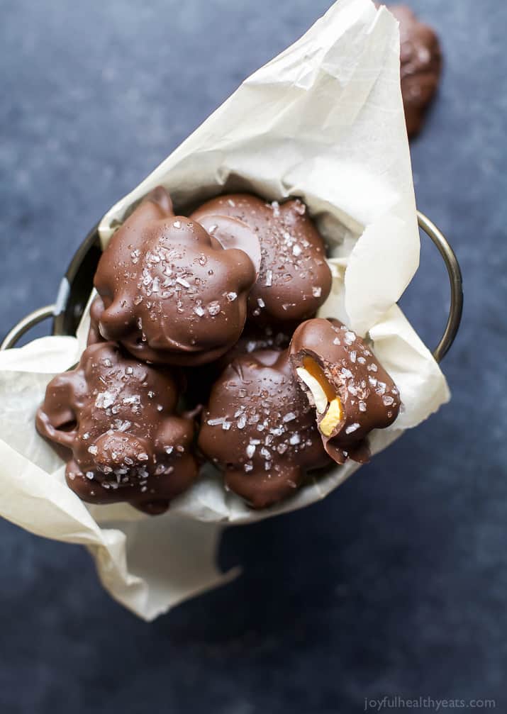 Top view of Espresso Cashew Clusters with sea salt in a paper-lined tin