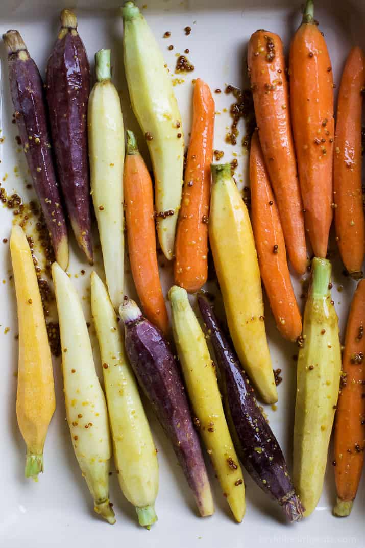 Jazz up your Carrots during the holidays with these RAINBOW MAPLE DIJON GLAZED CARROTS. Sprinkle them with some fresh herbs for an extra pop of flavor! These are a must for your dinner table this Thanksgiving! | joyfulhealthyeats.com #glutenfree