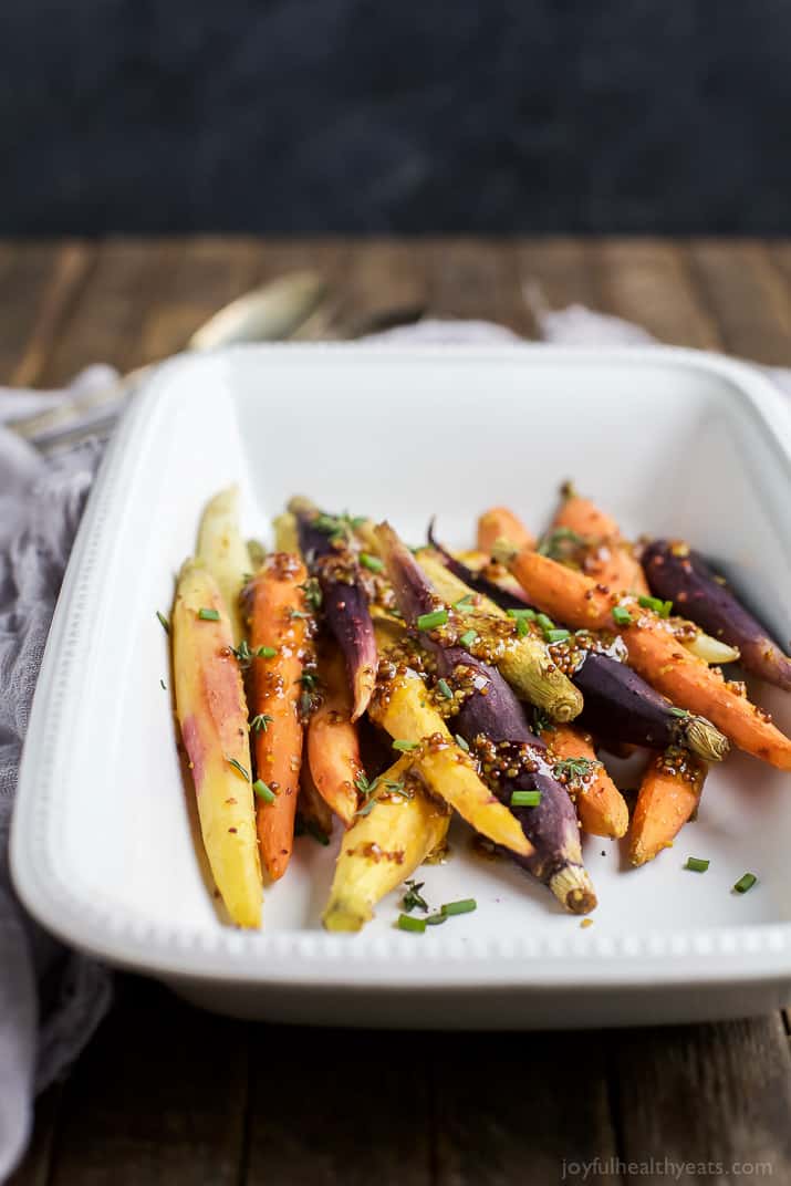 Jazz up your Carrots during the holidays with these RAINBOW MAPLE DIJON GLAZED CARROTS. Sprinkle them with some fresh herbs for an extra pop of flavor! These are a must for your dinner table this Thanksgiving! | joyfulhealthyeats.com #glutenfree