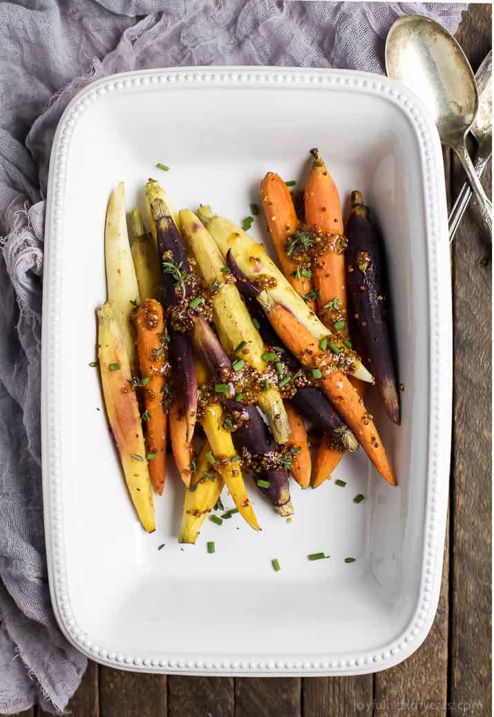 Jazz up your Carrots during the holidays with these RAINBOW MAPLE DIJON GLAZED CARROTS. Sprinkle them with some fresh herbs for an extra pop of flavor! These are a must for your dinner table this Thanksgiving! | joyfulhealthyeats.com #glutenfree