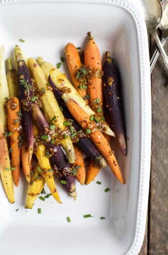 Jazz up your Carrots during the holidays with these RAINBOW MAPLE DIJON GLAZED CARROTS. Sprinkle them with some fresh herbs for an extra pop of flavor! These are a must for your dinner table this Thanksgiving! | joyfulhealthyeats.com #glutenfree