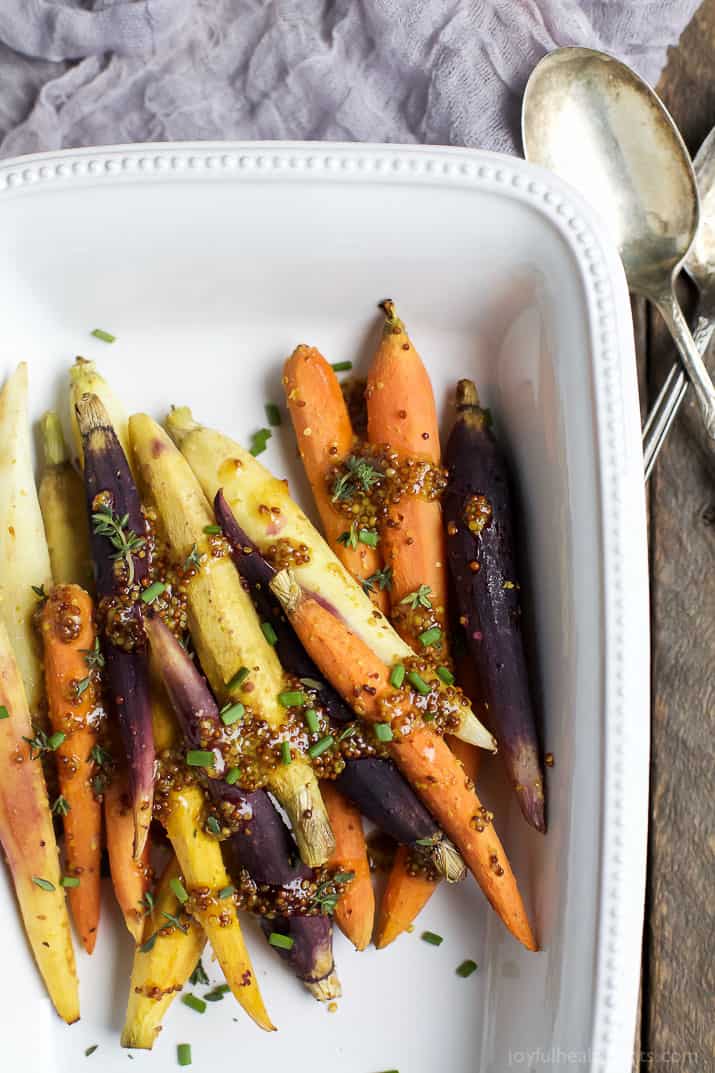 Jazz up your Carrots during the holidays with these RAINBOW MAPLE DIJON GLAZED CARROTS. Sprinkle them with some fresh herbs for an extra pop of flavor! These are a must for your dinner table this Thanksgiving! | joyfulhealthyeats.com #glutenfree