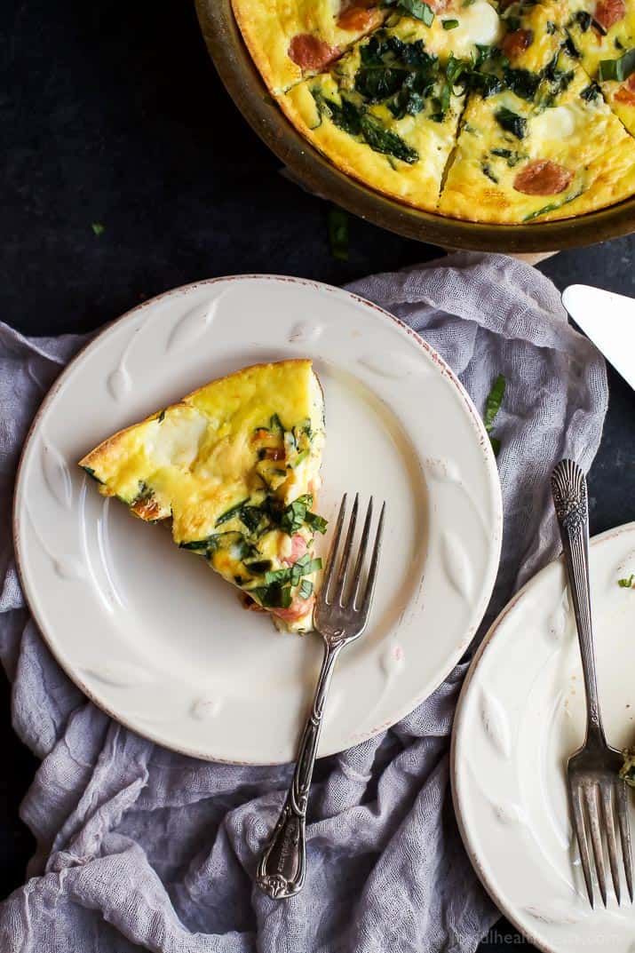 ROASTED TOMATO CAPRESE FRITTATA, an easy yet fancy looking holiday recipe that's perfect for breakfast, brunch or lunch! Filled with melted mozzarella, fresh basil, garlic infused spinach and roasted tomato - it's pretty much divine! | joyfulhealthyeats.com