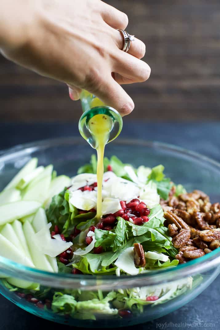 Shaved Brussel Sprout Salad filled with apples, pomegranate, candied pecans, and white cheddar cheese then tossed with a light Lemon Vinaigrette. This Brussel Sprout Salad is the perfect side dish for the holidays! | joyfulhealthyeats.com #glutenfree