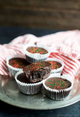 A few Thin Mint Oreo Bites wrapped in liners and topped with red and green Christmas sprinkles | joyfulhealthyeats.com