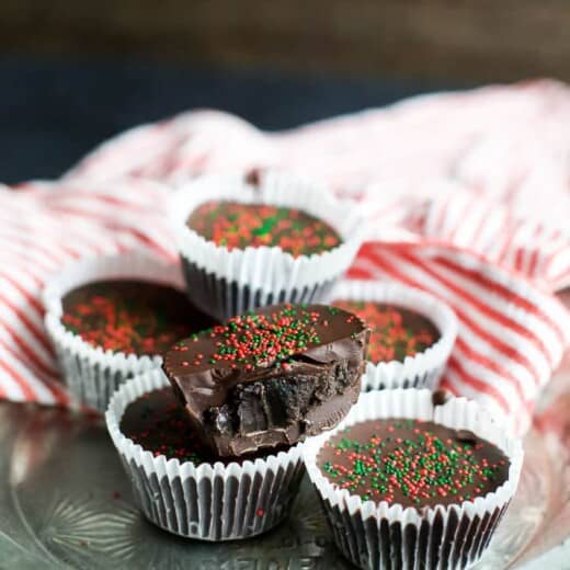 A few Thin Mint Oreo Bites wrapped in liners and topped with red and green Christmas sprinkles | joyfulhealthyeats.com